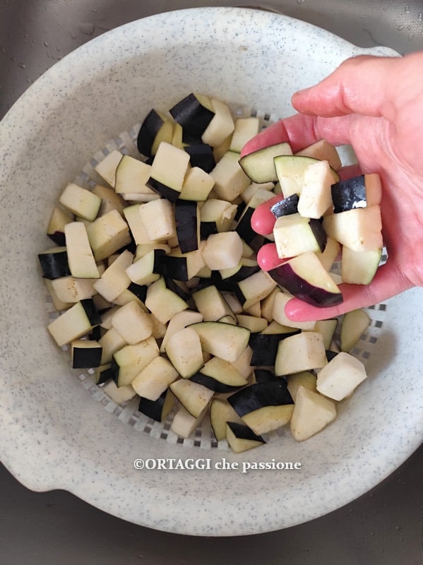 salted eggplants and cubes in the colander