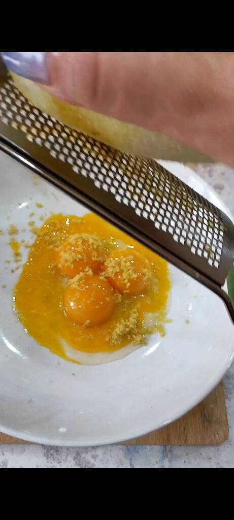 Make a cream of yolks, cheese, and lemon