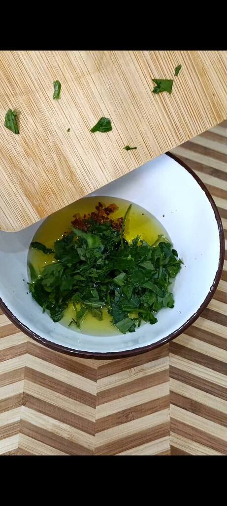 Emulsify oil, balsamic vinegar, salt, chili flakes, mint, and chopped parsley