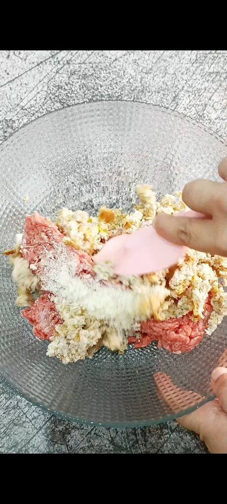 Mixing meat with Parmesan and breadcrumbs