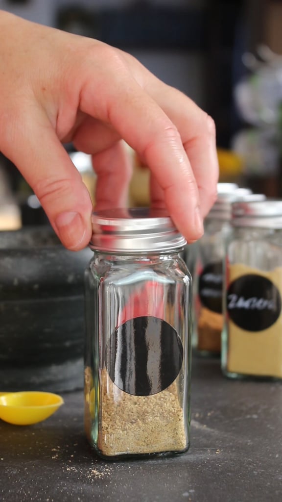 put the lid or cap on the jar with the savory recipe spice blend with white peppercorns, cloves, nutmeg, and ground ginger