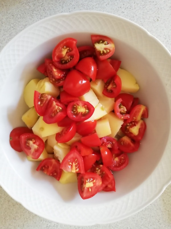 in a bowl potatoes and cherry tomatoes