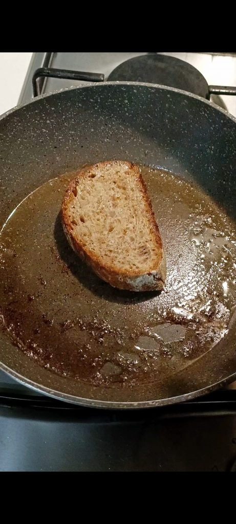 Put the bread slice in a pan with a knob of butter
