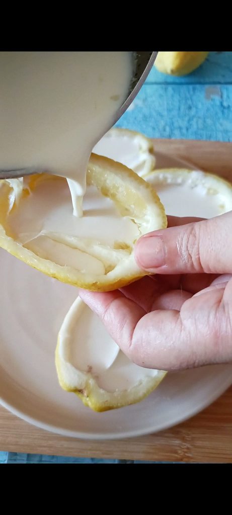 Pour the cream into the lemon shells