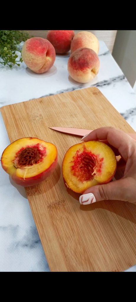 Cut the peaches in half, removing the pit