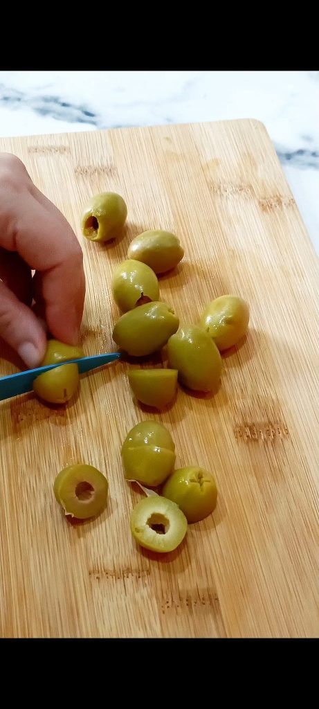 Cut the olives in half