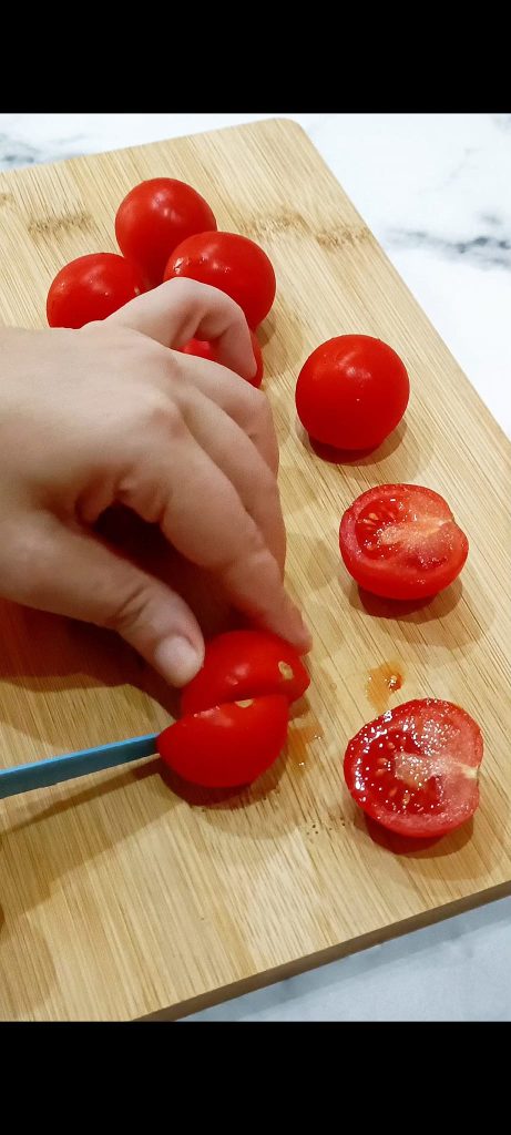Cut the cherry tomatoes in half