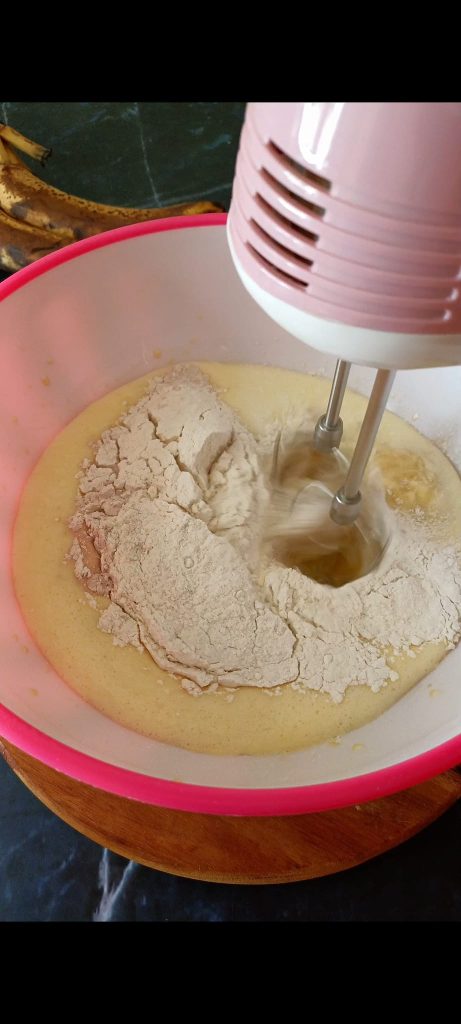 Adding flour, baking powder, and cinnamon