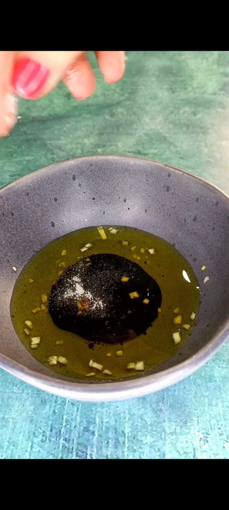 Prepare the emulsion with oil, garlic, balsamic vinegar, salt, and pepper