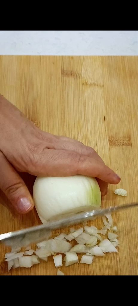 Chopping onion, garlic, and sage