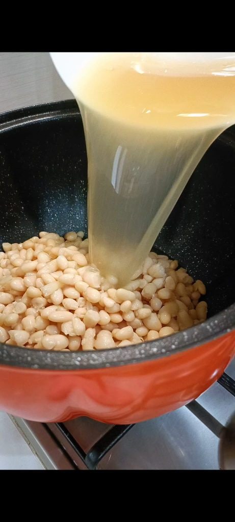 Adding beans and bean cooking water