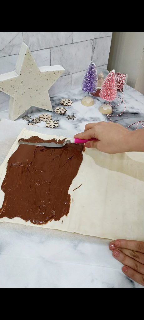 Spread Nutella on half of the puff pastry