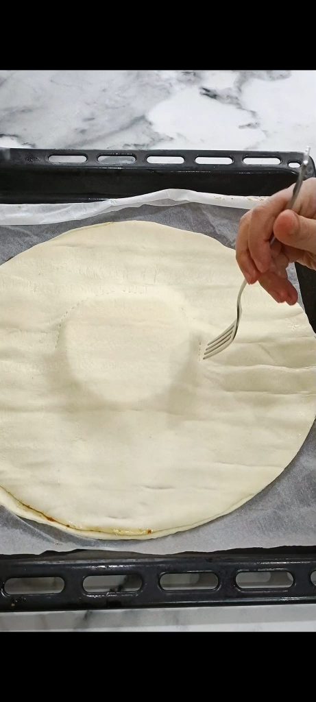 Cover with a second puff pastry sheet and prick with a fork