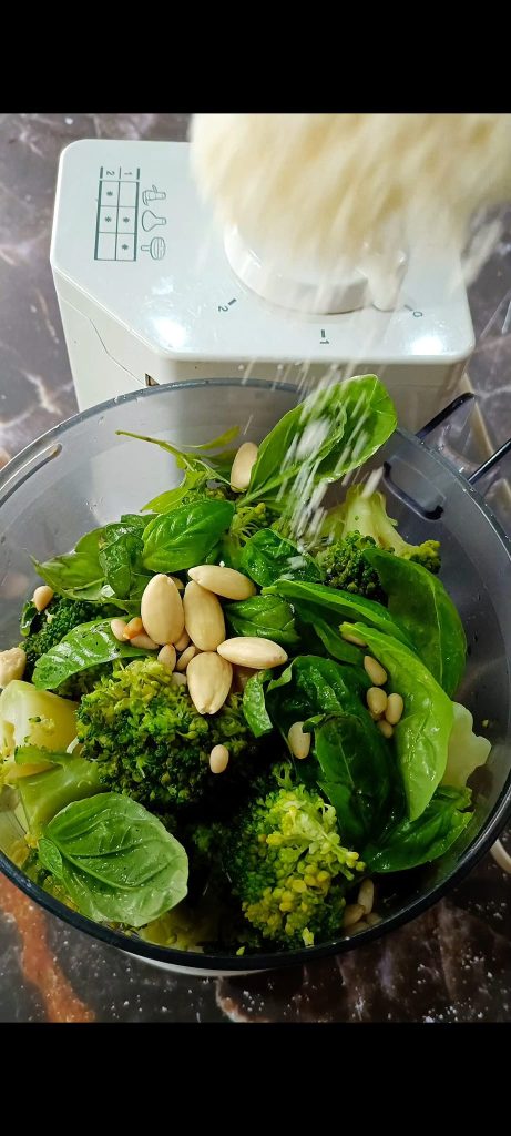 We also add pine nuts, almonds, Parmesan, oil, and salt