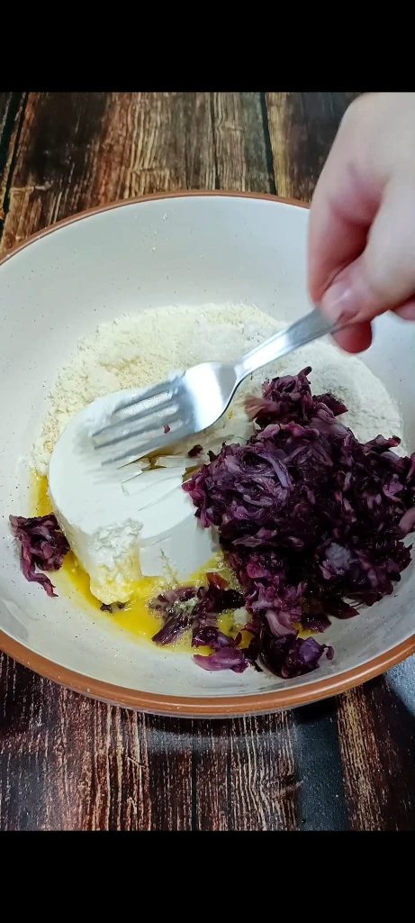 Combine an egg, flour, grated Parmesan, radicchio, and salt