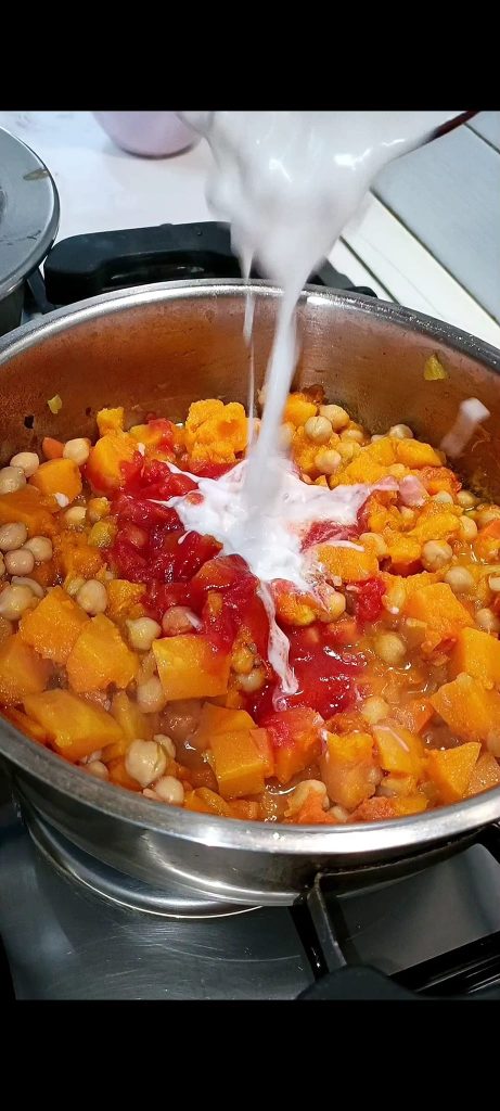 Add chickpeas, coconut milk, and tomato puree