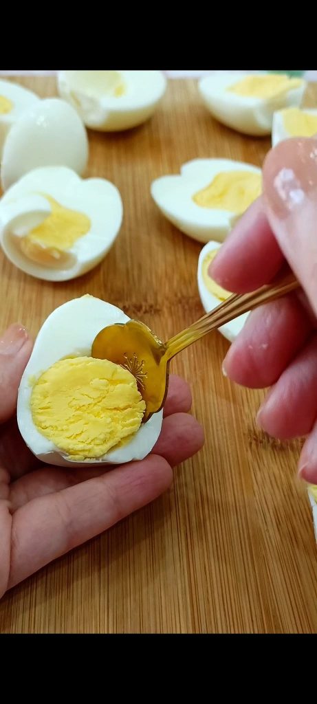 Removing the yolks with a teaspoon