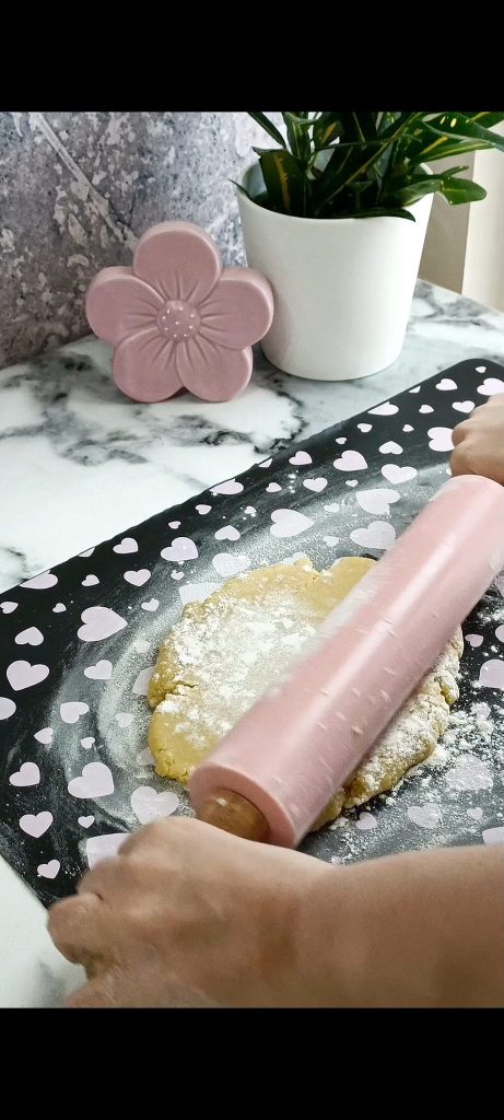 Shortcrust pastry on floured surface and rolling pin