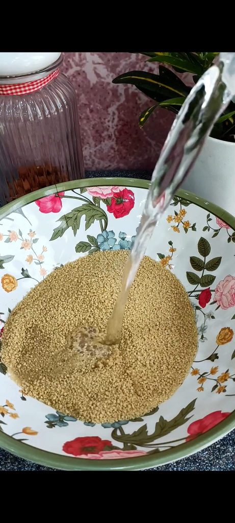 Couscous in a bowl with water and oil