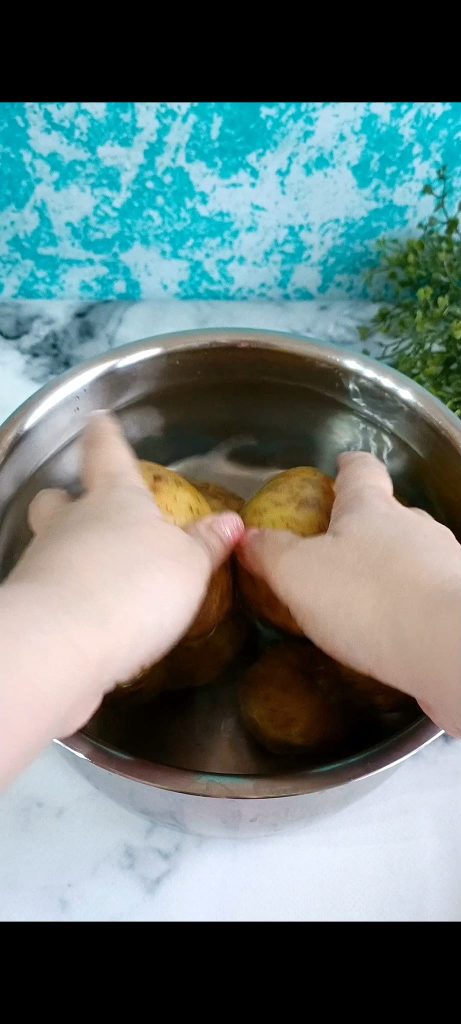 Potatoes in a pot with cold water