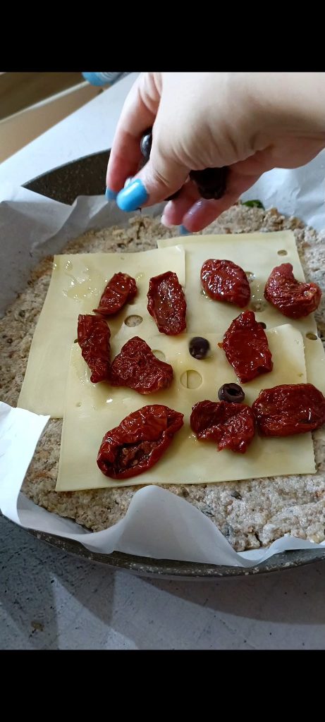 Fill with emmental, sun-dried tomatoes, and black olives