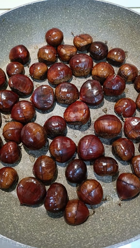 Placing chestnuts in the pan