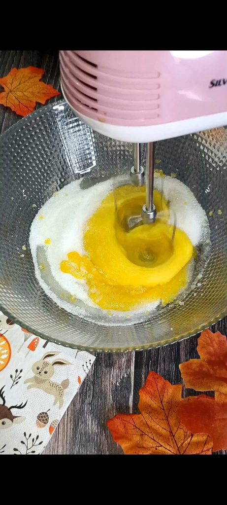 Adding the sugar and mixing with electric beaters