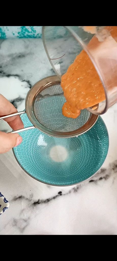 Straining the mixture to obtain a cream