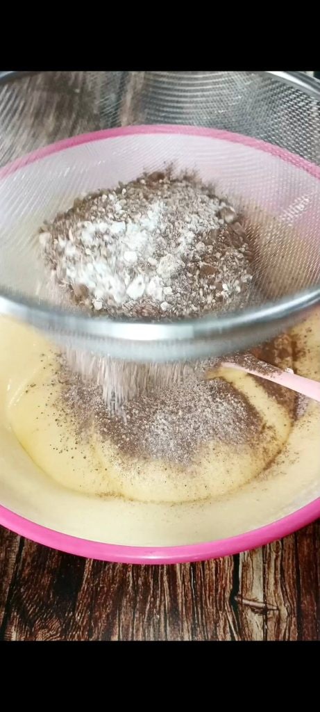 We add flour, cocoa, and baking powder