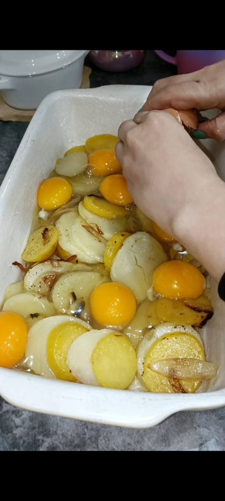 Crack the eggs over the potatoes