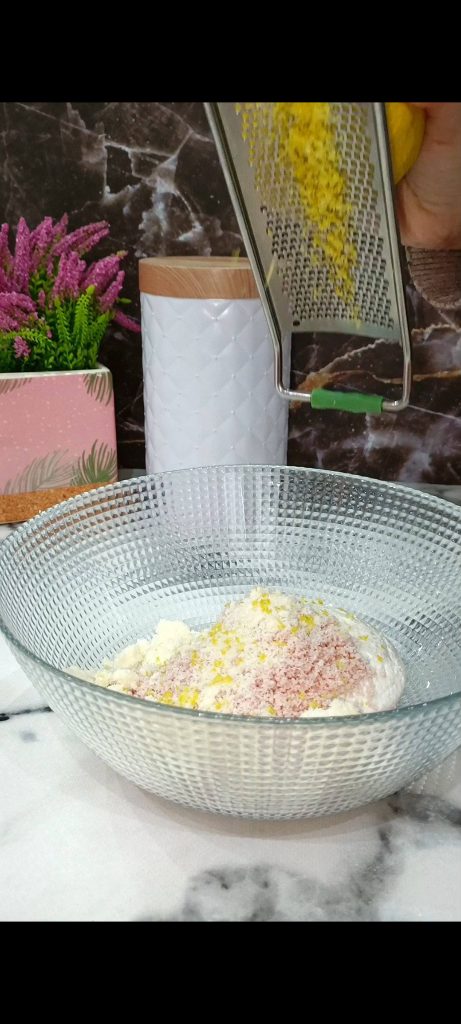 Prepare the filling with ricotta, chopped cooked ham, lemon zest, and grated Parmesan