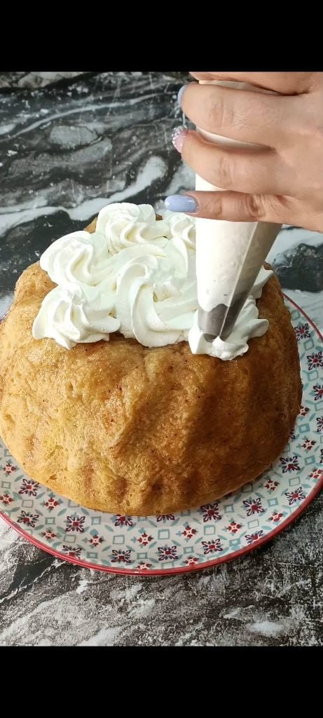 Decorating the baba with whipped cream