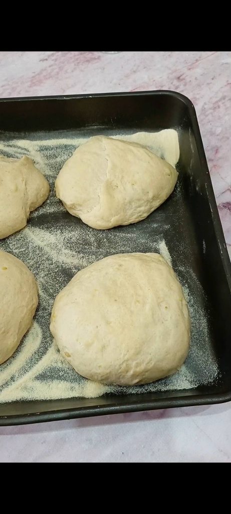 Dividing the dough into 4 loaves and letting them rise