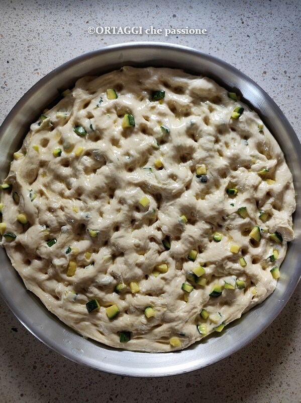 spread the dough and create the classic dimples with fingers