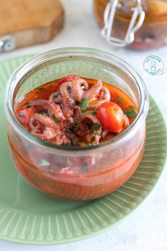 small octopuses cooked in tomato inside the jar in the microwave