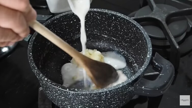 Adding the milk to the roux