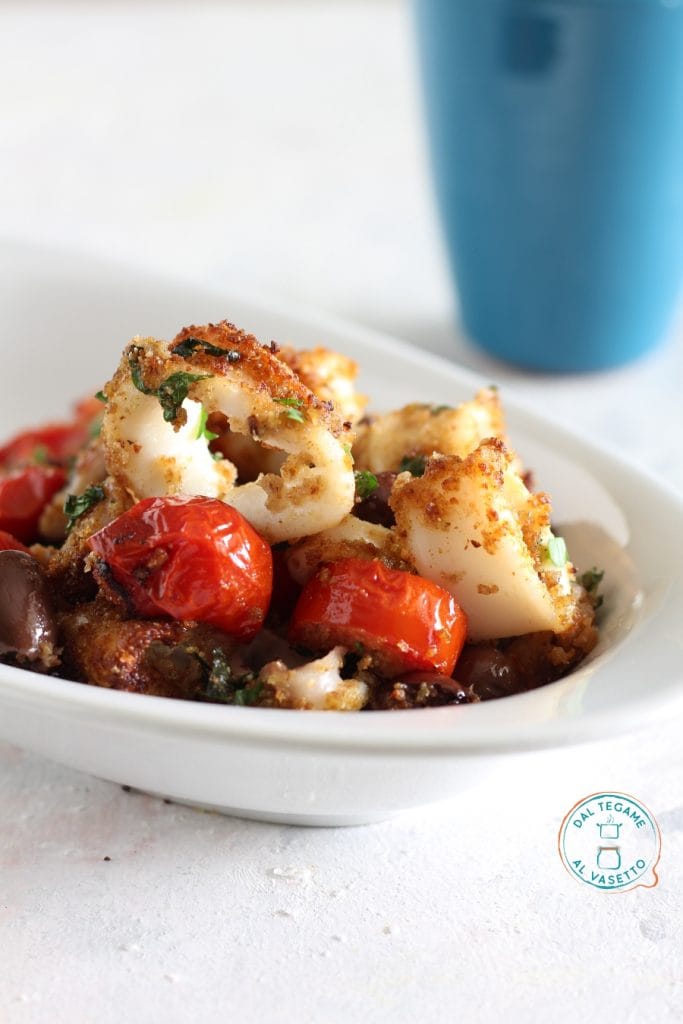 breaded squid rings in air fryer with cherry tomatoes, breadcrumbs, and olives