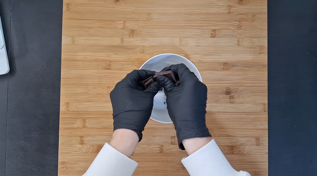 Breaking dark chocolate into small pieces