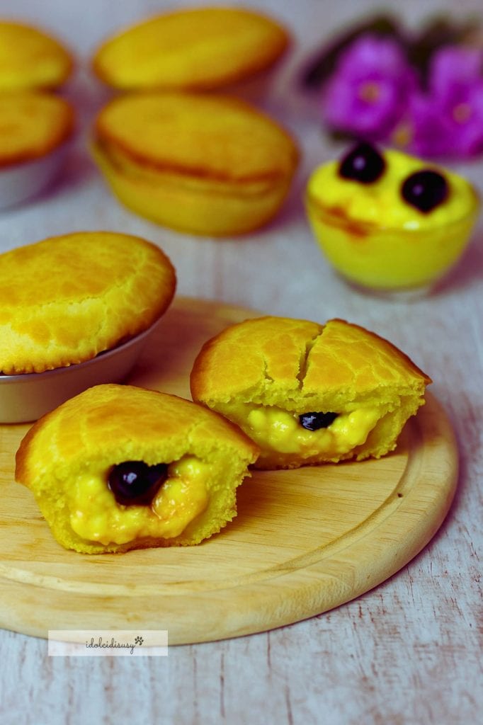 leccese pasticciotti with lemon cream and two sour cherries cut in half on wooden cutting board