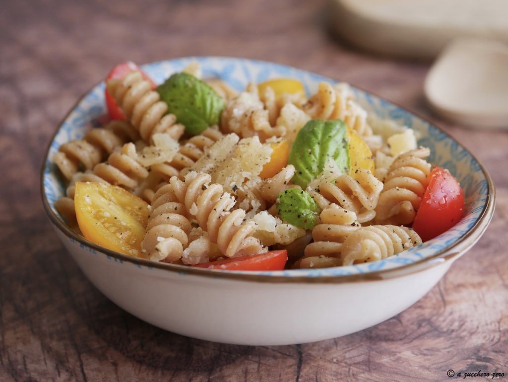 Cold pasta with cherry tomatoes, basil, and parmesan