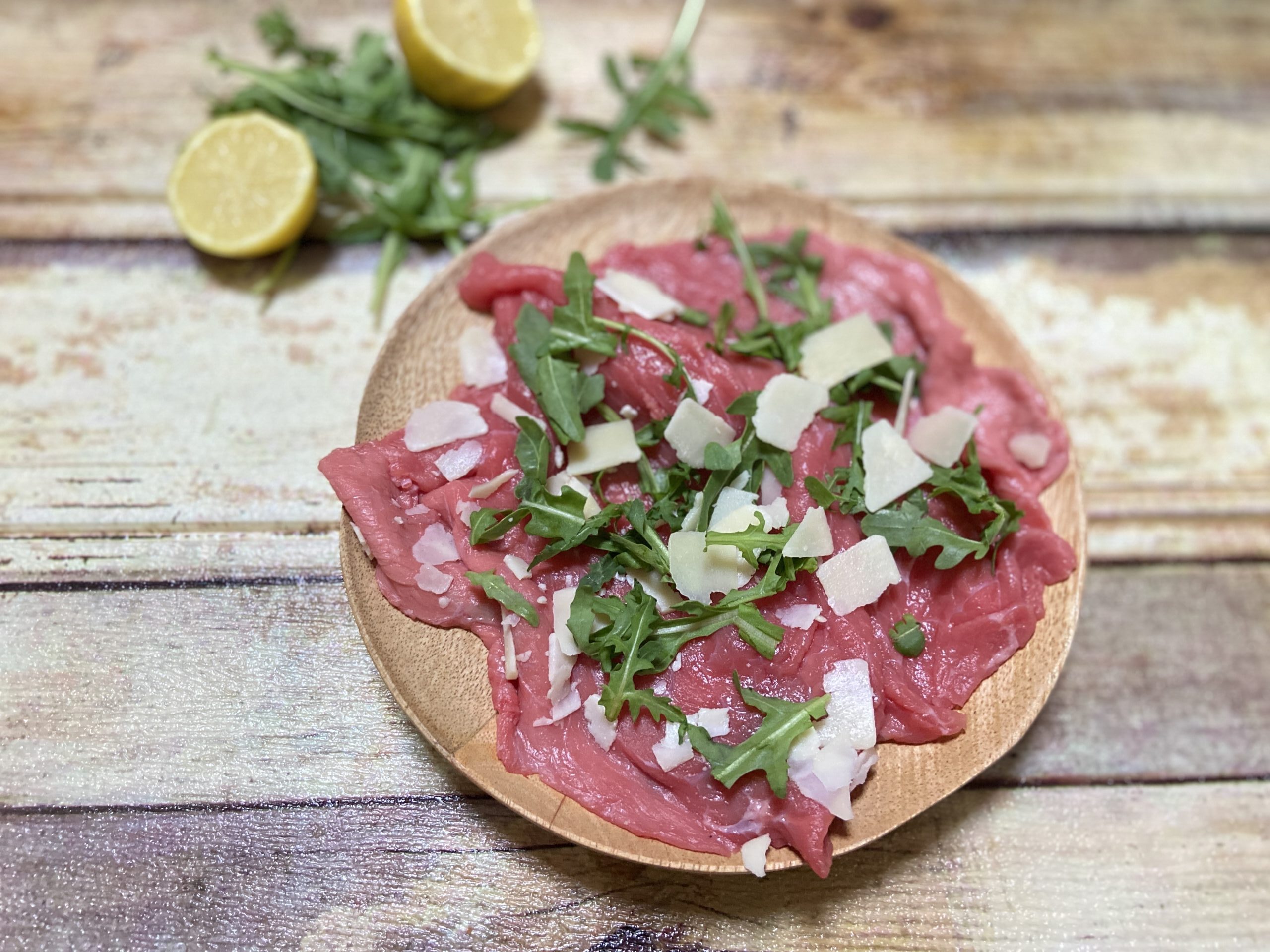 Raw meat with arugula and Parmesan