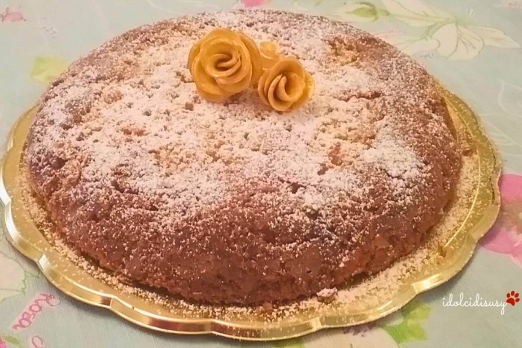 Lemon caprese cake decorated with powdered sugar and sugar paste roses