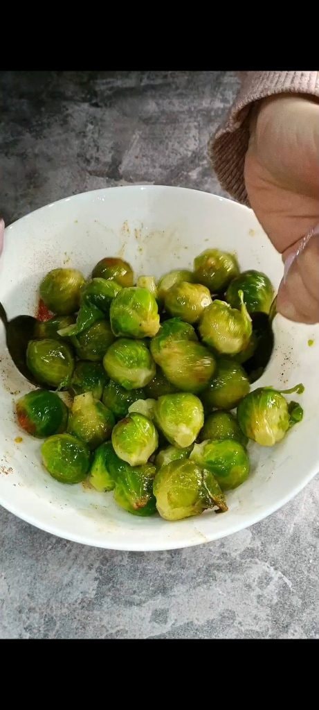 Season the Brussels sprouts and mix well
