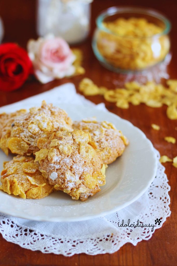 Desert rose cookies with corn flakes and powdered sugar, on a white plate with a lace placemat