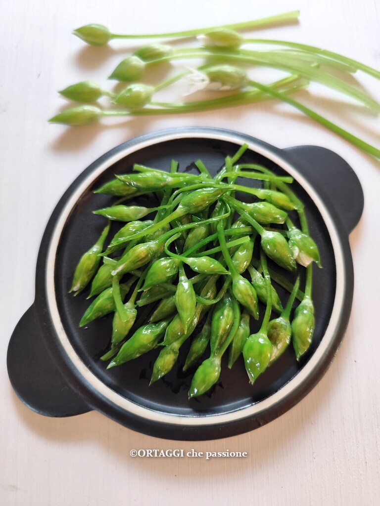 Wild garlic buds fried in a pan