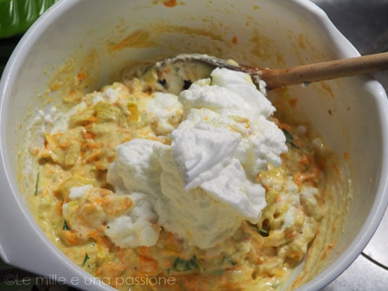 Whipped egg whites added to the mixture to make fritters with zucchini flowers
