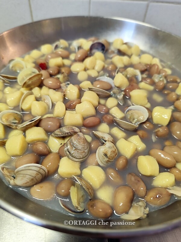 finish cooking gnocchi with clams and beans