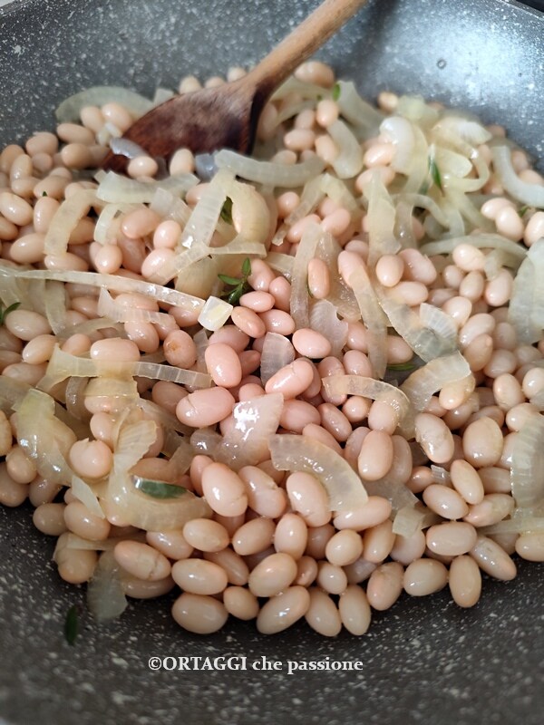 beans and onion cooked in a pan