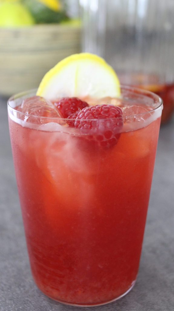 black iced tea with raspberries and lemon