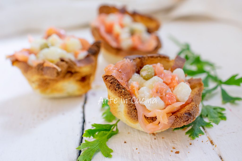 Bread baskets with salmon and Russian salad